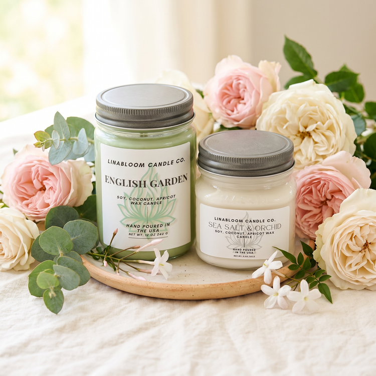 Floral candle collection — English Garden and Sea Salt & Orchid surrounded by fresh garden roses and eucalyptus