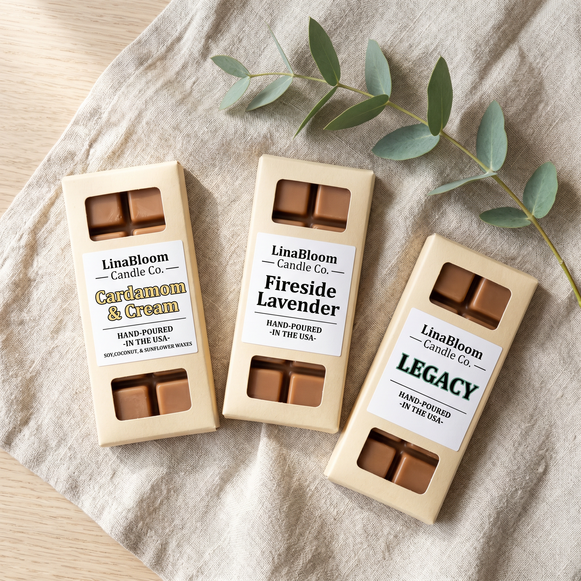 Three LinaBloom 1.5oz snap bar wax melts — Cardamom & Cream, Fireside Lavender, Legacy — fanned out on linen