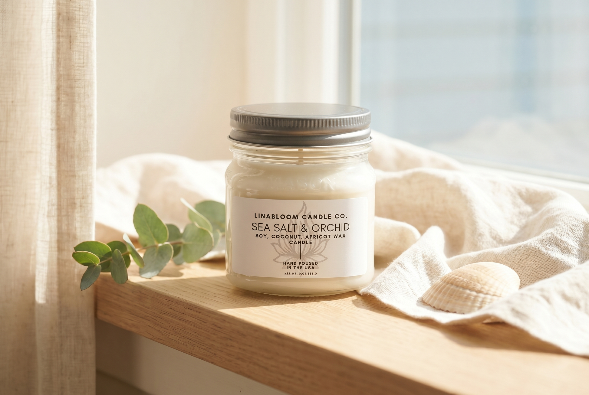 Lina Bloom Sea Salt & Orchid candle on a sunlit windowsill with linen and eucalyptus