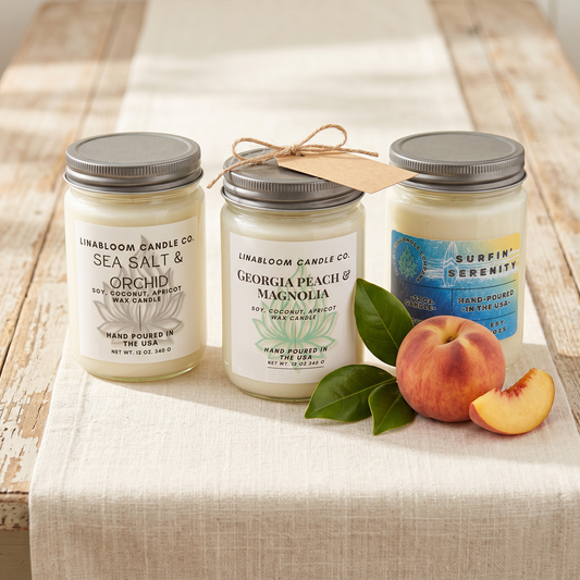 The Southern Trio — Sea Salt & Orchid, Georgia Peach & Magnolia, and Surfin' Serenity 12oz candles with magnolia leaves and a Georgia peach